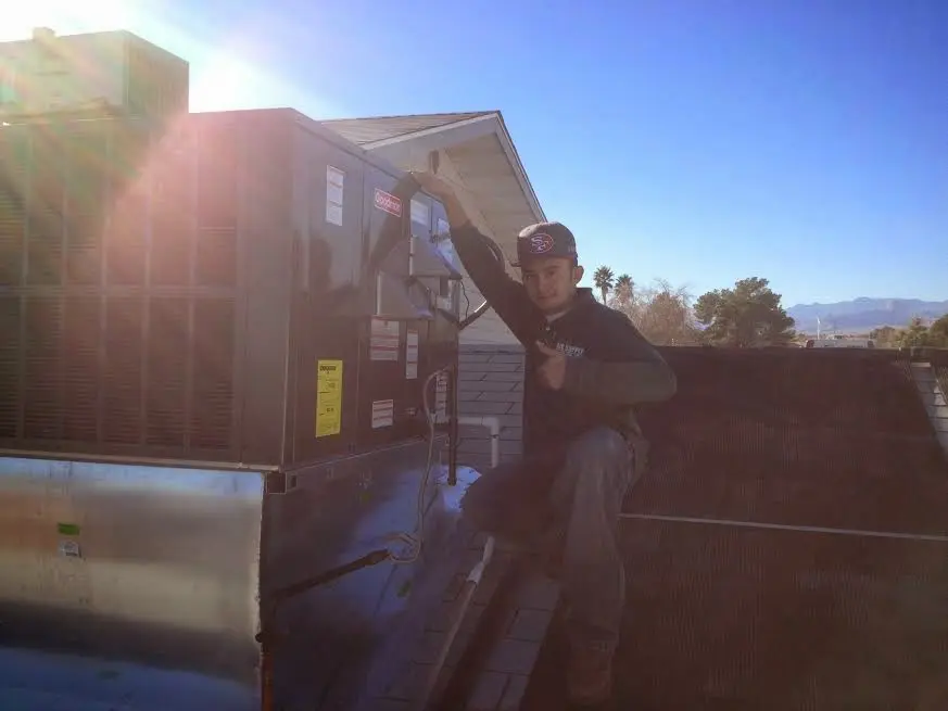 HVAC technician performing HVAC Inspection on a rooftop unit in Bensenville
